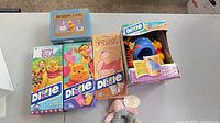 Group shot of four Dixie cup boxes, Treasure Craft figurine box, and plush Piglet