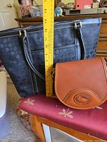 Front view showing size comparison of tote and crossbody with ruler