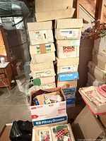 Stack of labelled boxes and open box showing fabrics, patterns and notions