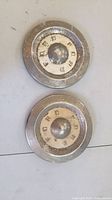 Front view of both Ford hub caps showing design and wear