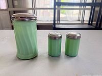 front view of three jadeite glass shakers