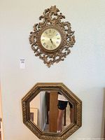 Wall clock and mirror hanging on wall