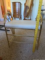 side view showing gold metal frame, cushion, height measurement
