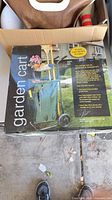 Retail box front showing image of assembled green garden cart with bag and wheels