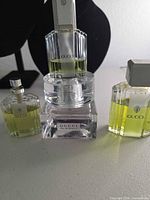 Four Gucci perfume bottles showing labels, colors and caps