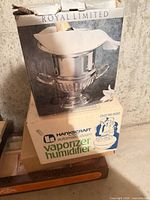 Both boxed items stacked: Royal Limited ice bucket box atop Hankscraft vaporizer box