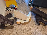 All three pairs laid out on carpet showing soles and uppers