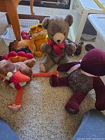 Group shot of all five plush animals on carpet
