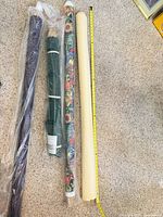 Four rolls side by side with measuring tape