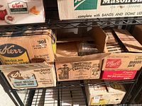 Shelf containing five original boxes of Kerr, Ball and Anchor Hocking Mason jars