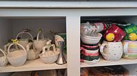 Cabinet view showing Gracie China basket dishes, mugs, bowls and plates