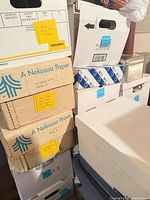 Stacked bankers boxes labelled with party and craft supplies