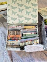 Open butterfly box showing stacked sealed napkin packs and ribbons