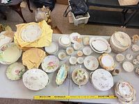 overview of mixed floral porcelain dinnerware on table