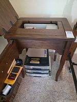 Top view showing sewing cabinet opening and mounted Necchi machine plus plastic drawer tower underneath