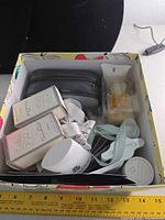 Box showing assorted Oscar de la Renta minis, lotion, ribbon and pouch