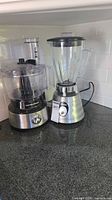 Osterizer blender and Hamilton Beach food processor side by side on countertop