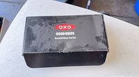 Closed black box labeled OXO Good Grips Essential Home Tool Set