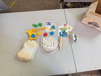 Entire set laid out showing mold, cutters, handle, rolling pin, booklets, box corner