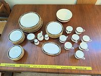 Full view of entire 54-piece dinnerware set spread on table