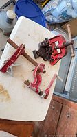 Top view of vise head, base, handle and two clamp jaws on table