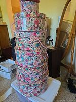 Stack of six floral hat boxes showing pattern, lids, handles
