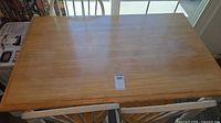 Top view of rectangular light oak table surface with wear