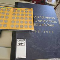 Collector's map and loose quarter holder page showing coins inserted