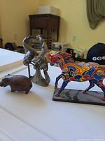 Three figurines: Painted Ponies horse, wooden hippo, metal-wood bird sculpture