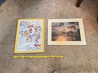 Both framed prints side by side with measuring tape for scale