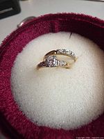 Both rings nested in box showing center stone and accents