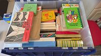 Top view of tote showing variety of boxed sets, booklets, loose paper
