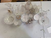 Group overhead view of all glass serveware items in lot