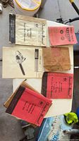 Group shot showing all six manuals spread on table