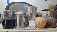All items grouped showing kettle, three aluminum pots, two canisters, tray, enamel mug