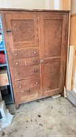 Full front view of armoire showing drawers and doors