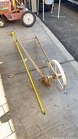 Side view showing full length of cultivator and measuring tape on ground