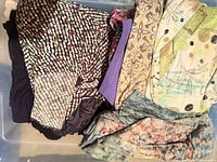 All tops folded in bin showing various prints and colours