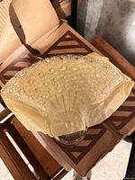 Clear pressed glass fan-shaped dish showing hobnail and starburst pattern