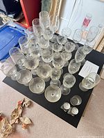 Top view of mixed stemware and tumblers arranged on tabletop