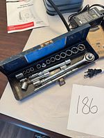 Open socket set showing ratchet, sockets, extensions and loose plug adapter