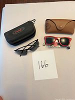 Overview of both sunglasses, both cases, spare lenses and cloth