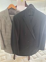 Front view of both jackets on hangers