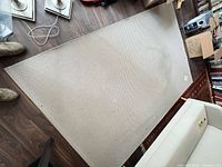 Full view of rectangular beige flatweave rug on floor