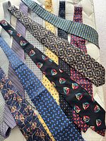 All eleven assorted neckties laid out showing patterns and colors