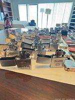 Front view of multiple open flip-top lighters in rows