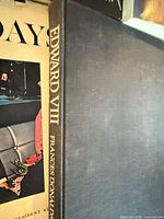 Spine of Edward VIII with adjacent Four Days cover and plain dark cloth board