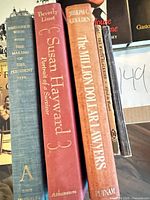Spines of several hardcover books including Susan Hayward biography and The Million Dollar Lawyers