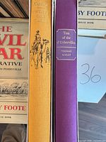 Spine view of Kipling, Hardy books with partial Foote jacket