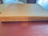 Spine of Chatelaine's Adventures in Cooking on beige cloth cover